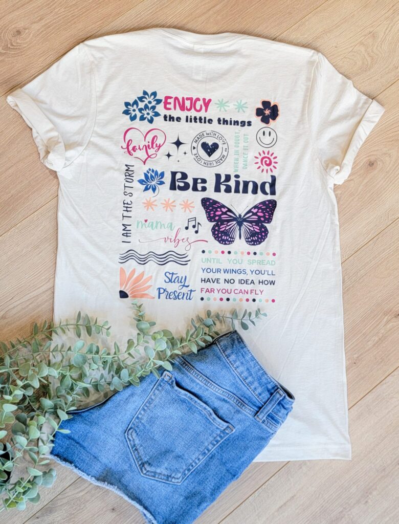 collage of graphics and quotes on back of off white shirt